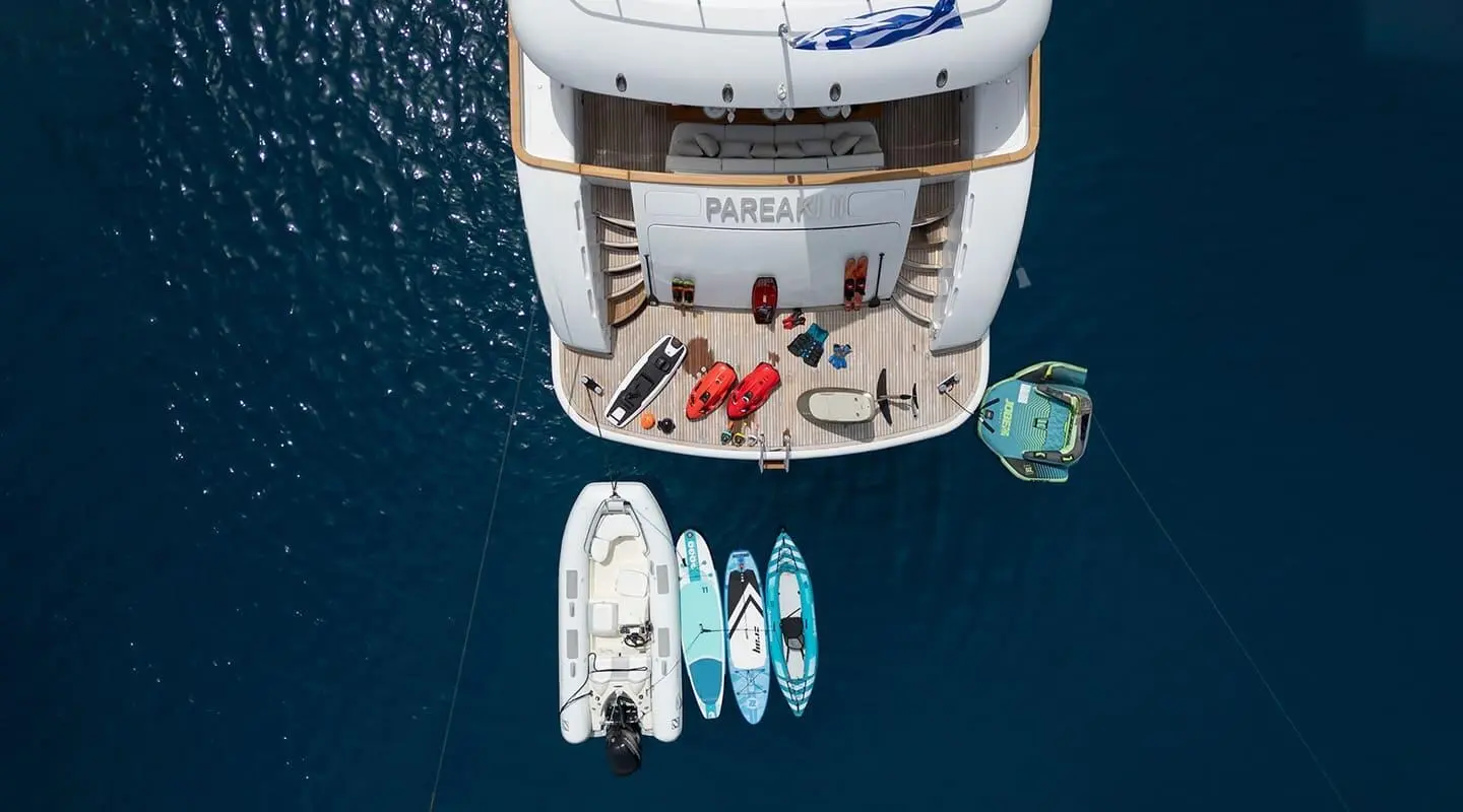 Pareaki II yacht docked with smaller boats alongside on calm water