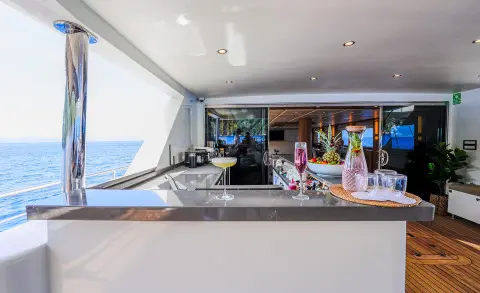 Aft deck bar on King Of The Sea yacht with seating and ocean view behind