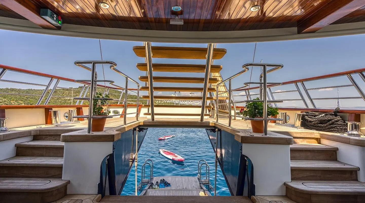 Casablanca yacht deck view with stairs, pool, and lounge chairs aboard
