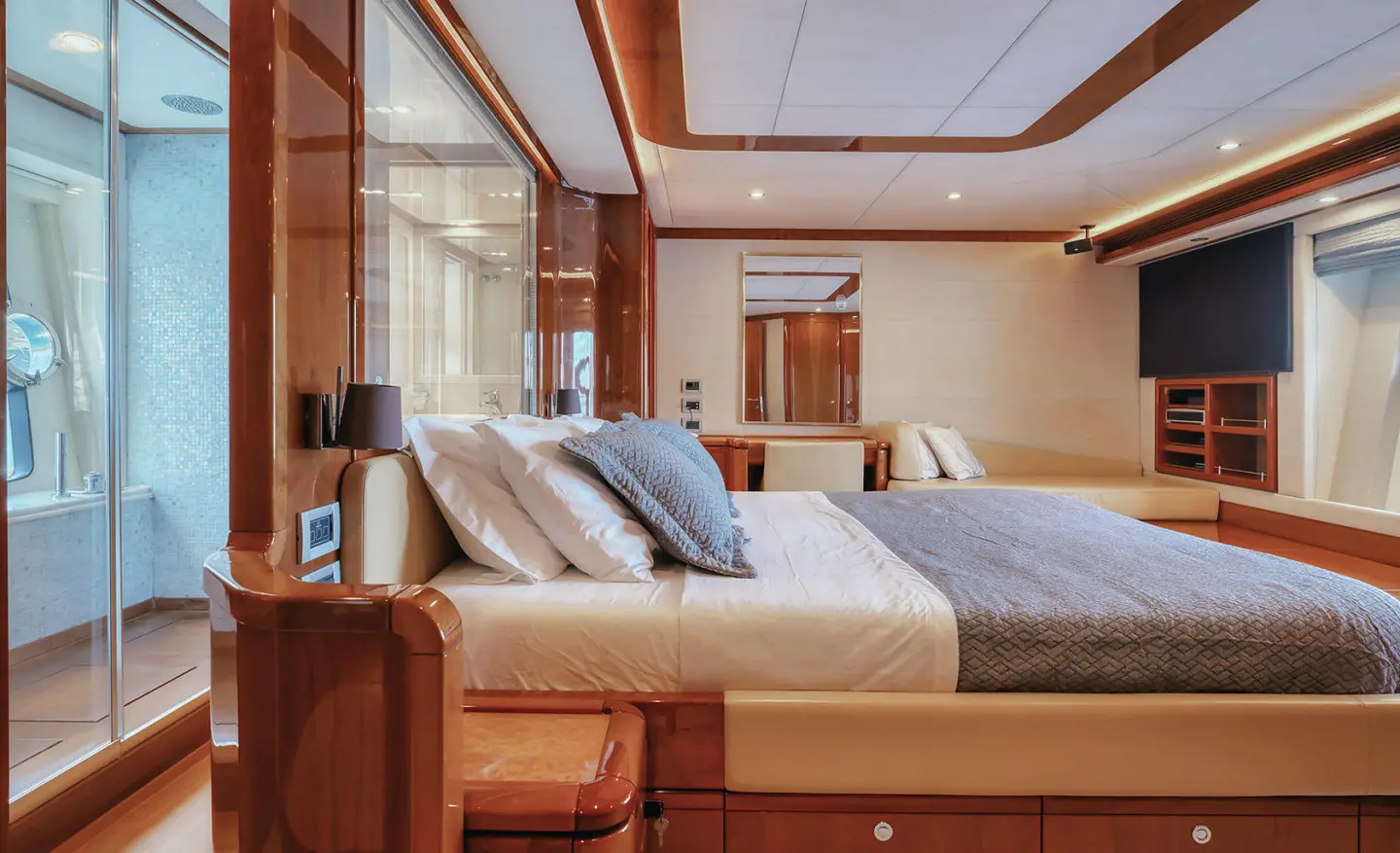 luxury yacht cabin with large bed and wooden decor, soft lighting