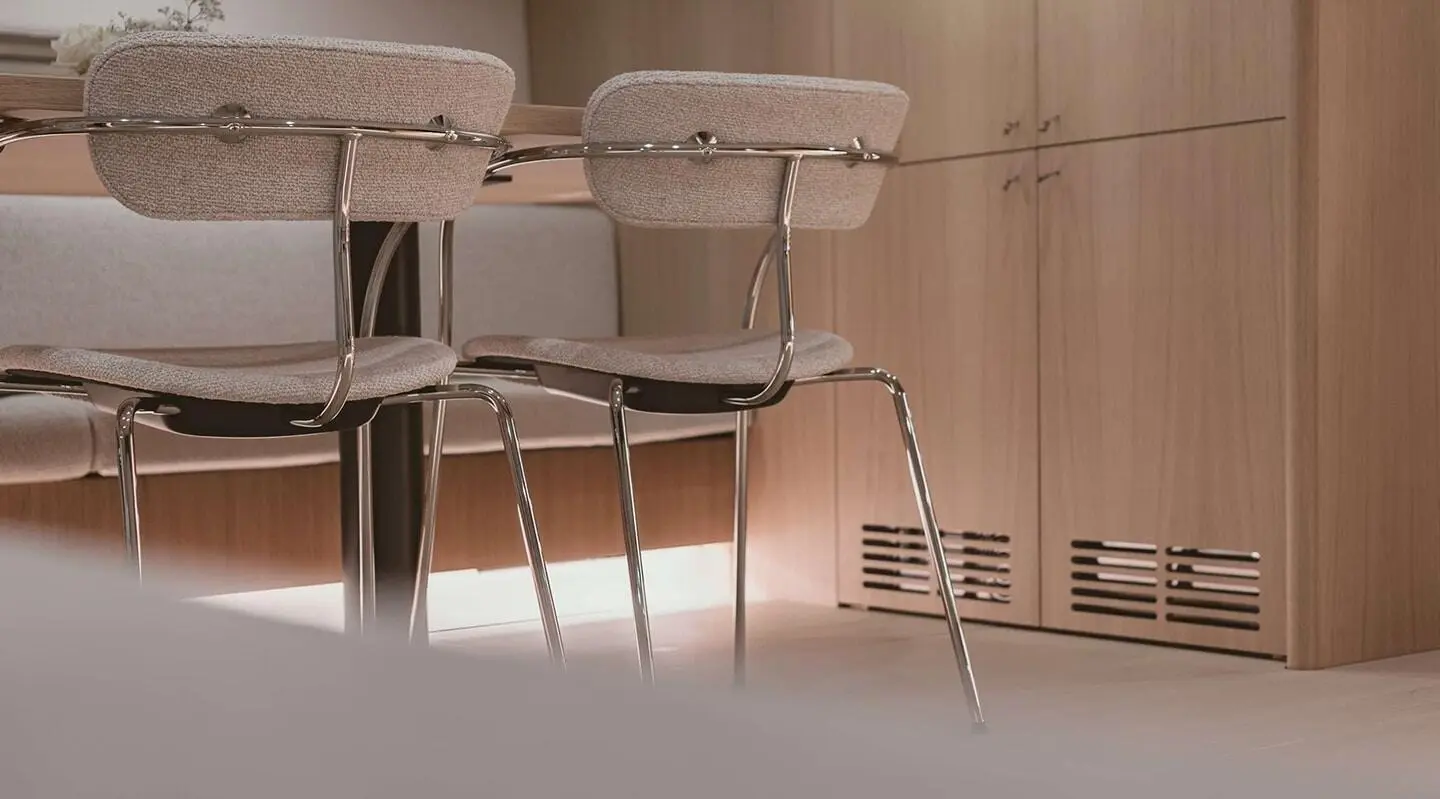 Interior of a yacht with wooden cabinets and modern fabric chairs