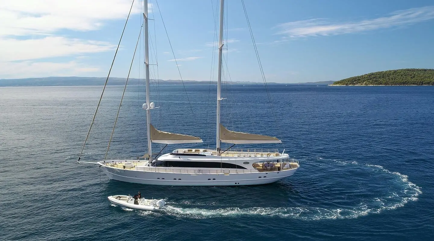 Acapella luxury sailing yacht anchored on calm blue sea, sails furled