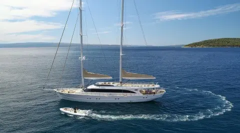 Acapella luxury sailing yacht anchored on calm blue sea, sails furled