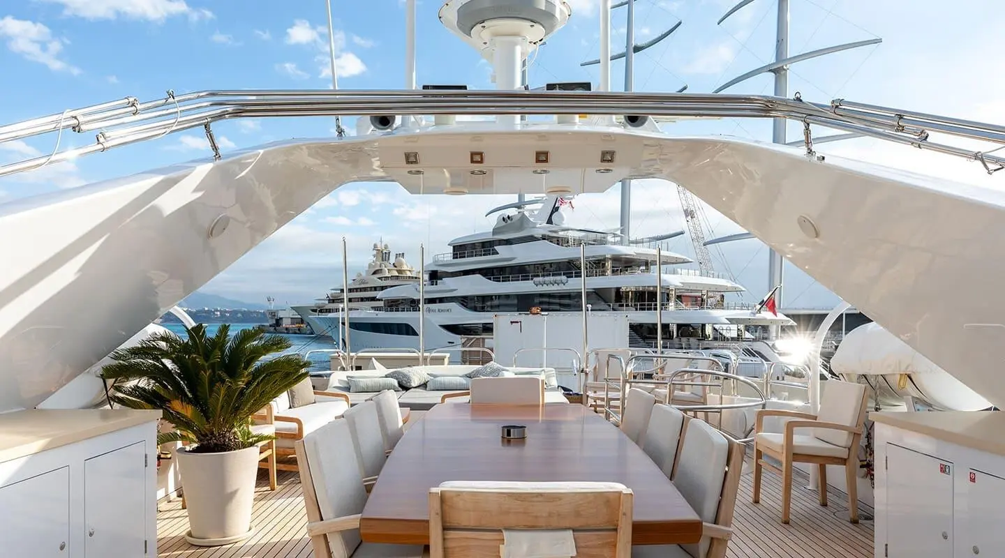 Luxurious yacht Brooklyn dining area with table, chairs, and ocean view