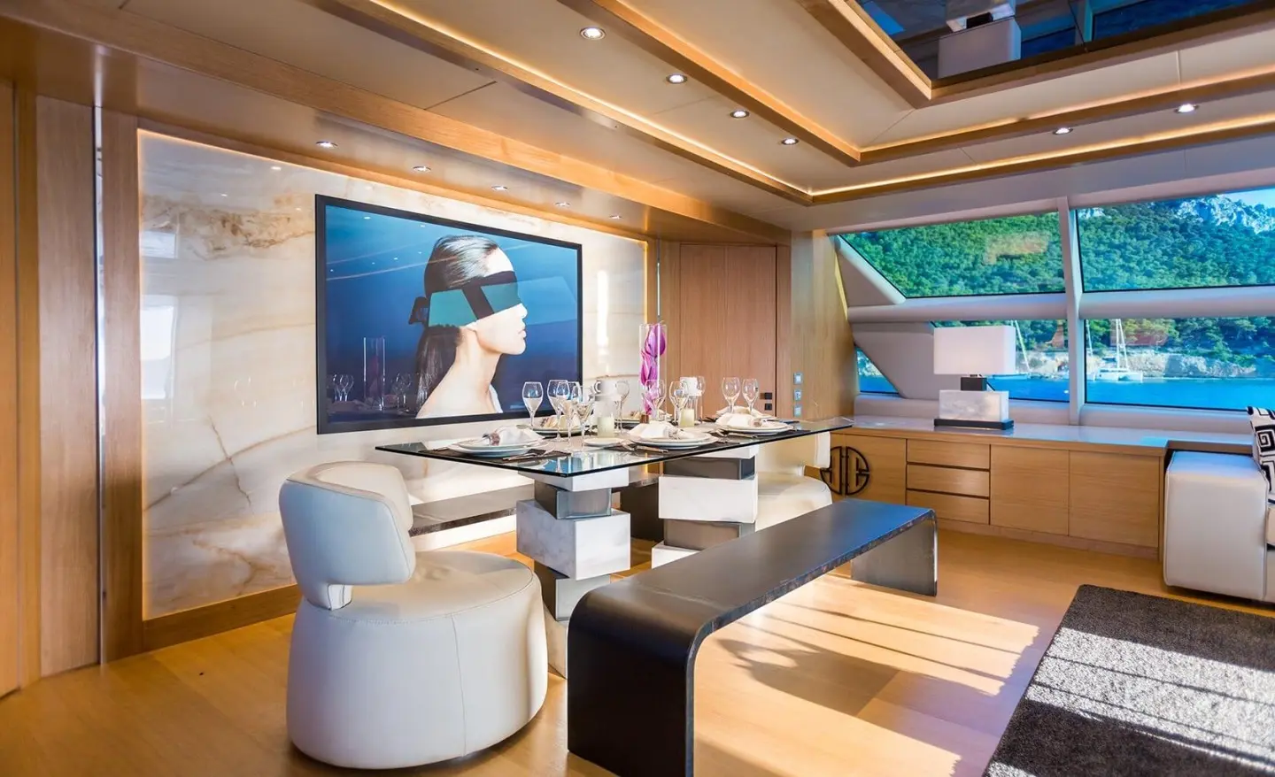 Aquarella yacht dining saloon at sunset with white chairs and wooden floor