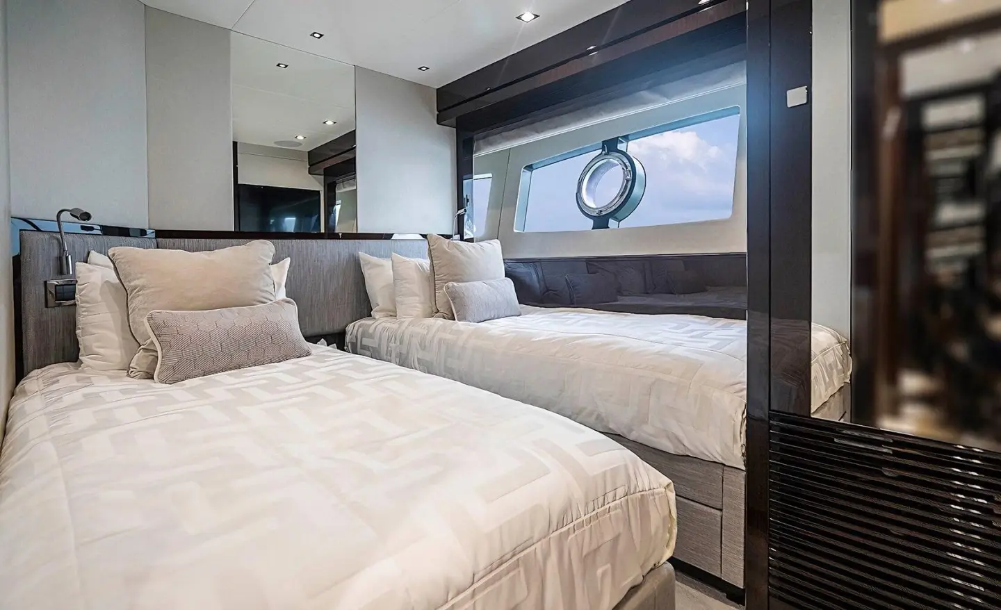 Interior of a luxury yacht cabin with two twin beds side by side