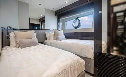 Interior of a luxury yacht cabin with two twin beds side by side