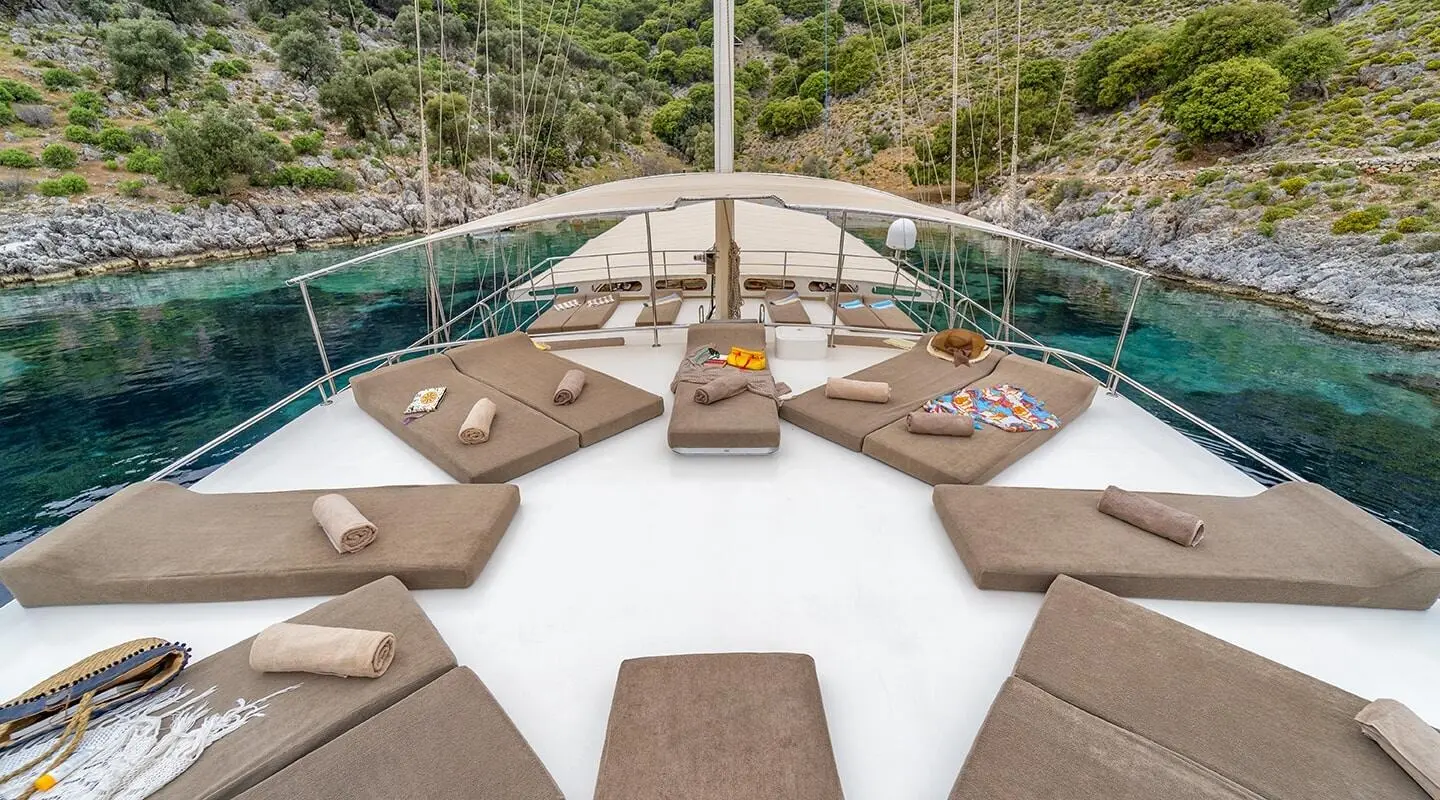 Tersane 8 yacht deck seating area with sun loungers at sunset