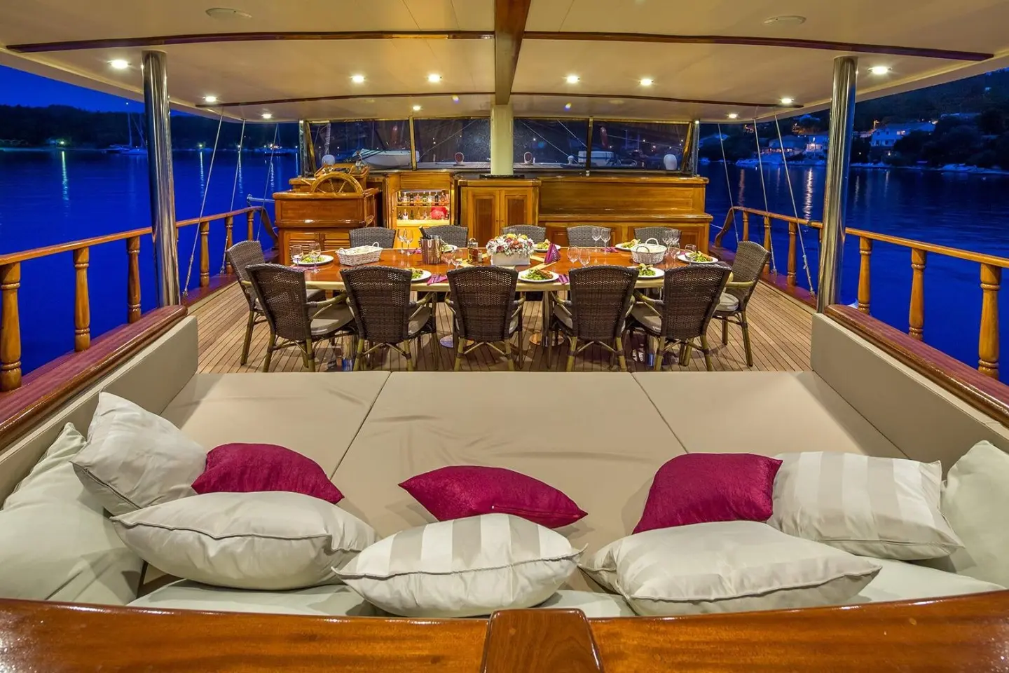 Evening on Morning Star yacht with dining area under blue lighting and seating