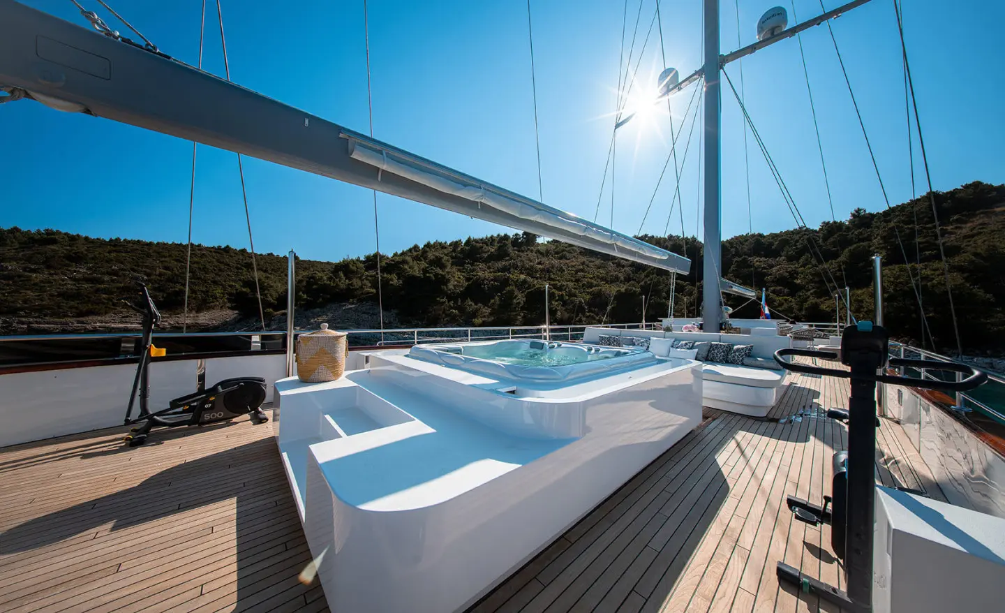 Nocturno motor yacht deck with white seating, sun loungers, and railing