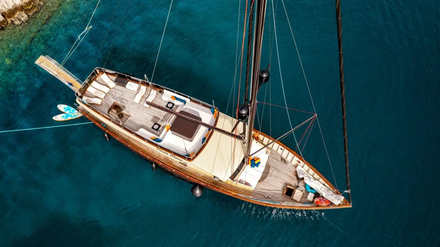 Top-down view of Santa Clara motor yacht at anchor with deck and mast visible