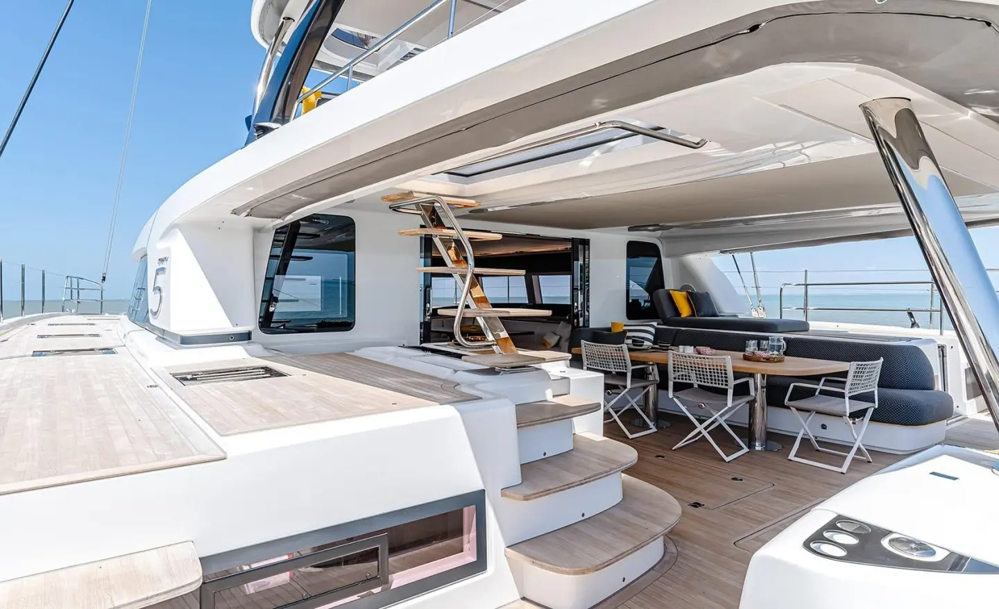 Outdoor dining area on Daiquiri yacht deck with seating and shaded awning