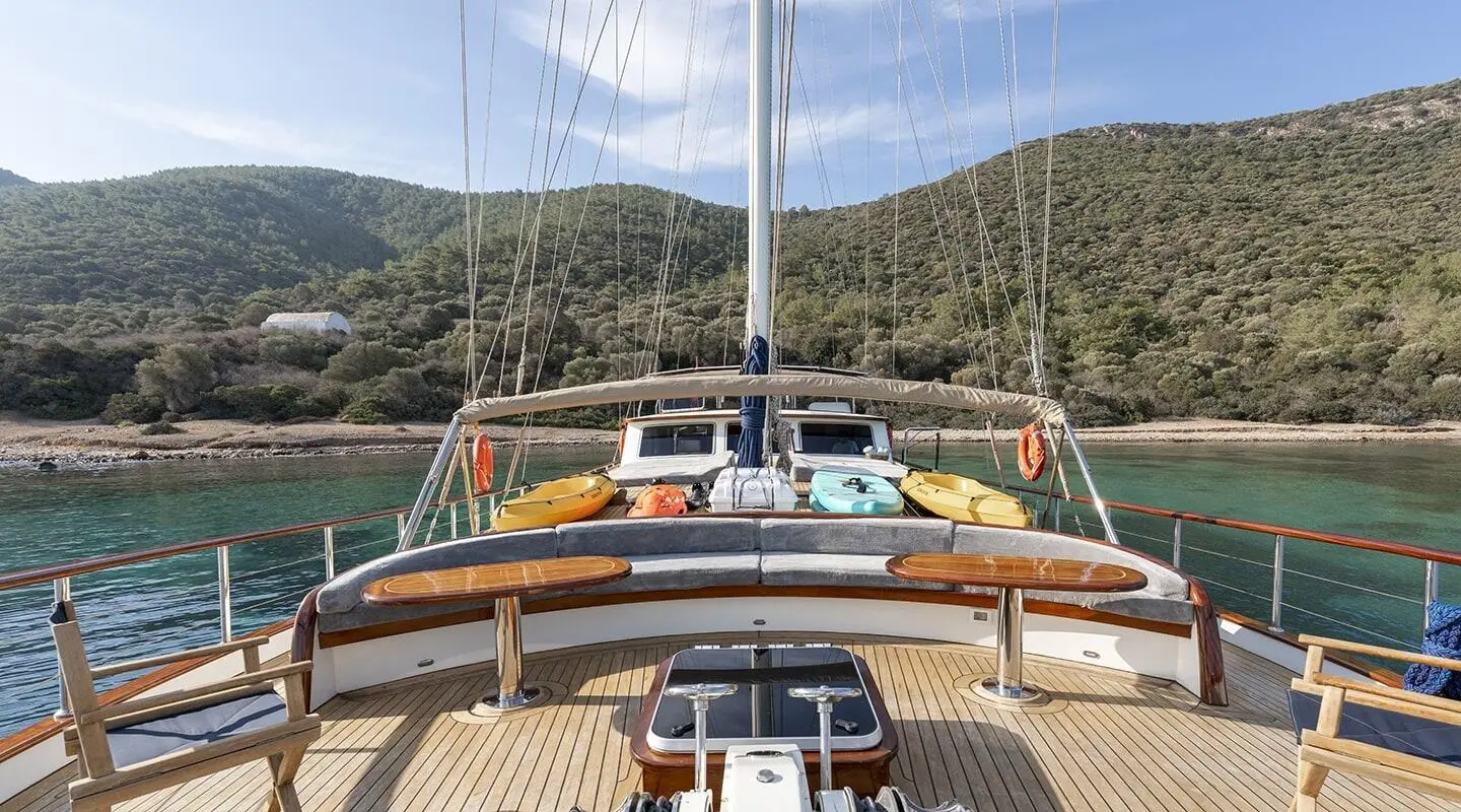 View from the yacht helm on Gozdem The One with sunlit deck and mountains