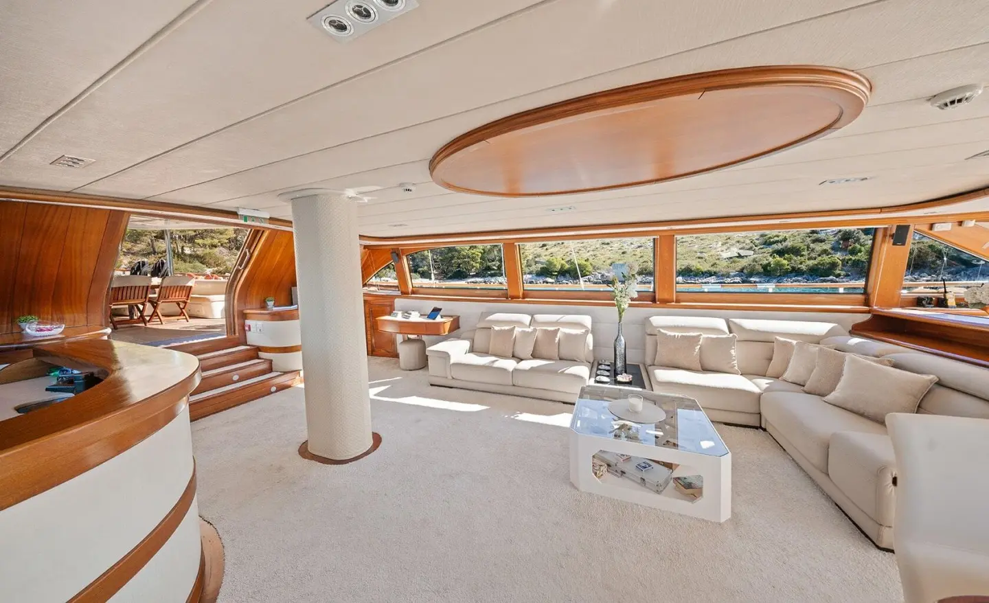 Alessandro I yacht deck with white lounge chairs overlooking water at sunset