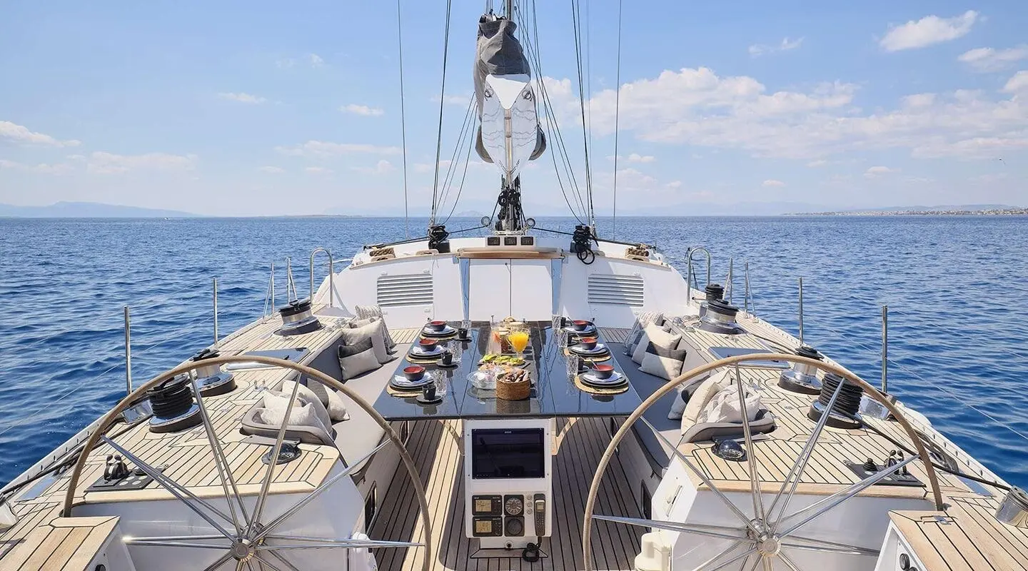Aizu yacht deck scene with table decorations and ocean view, forward bow