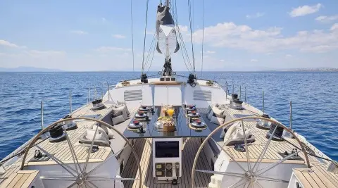Aizu yacht deck scene with table decorations and ocean view, forward bow