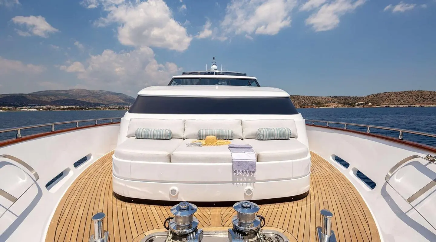 Front view of Grace luxury yacht docked with two mooring posts on wooden deck