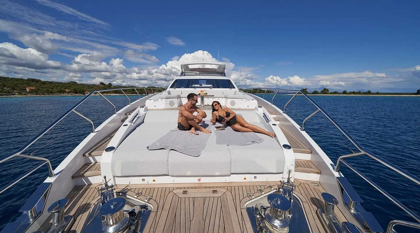 View from bow of Aluminia Too yacht with two people sunbathing on deck