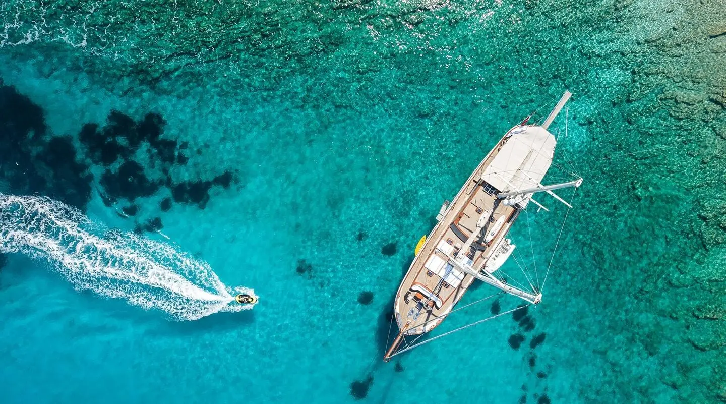 Aerial view of a luxury yacht Estrella De Mar anchored in turquoise waters at sunset