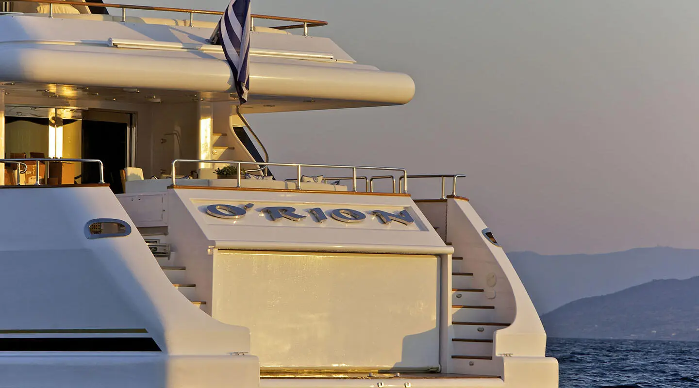 O'Rion luxury yacht stern deck at sunset, polished white hull and railings