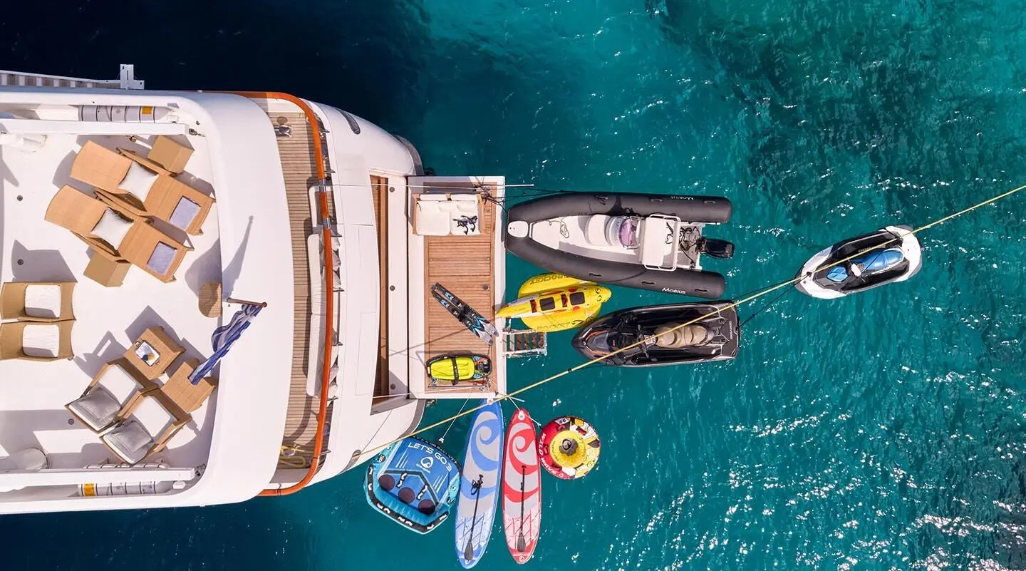 Aerial view of Mobius yacht anchored near small boats and swimmers