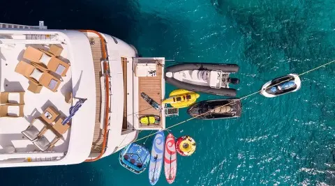 Aerial view of Mobius yacht anchored near small boats and swimmers
