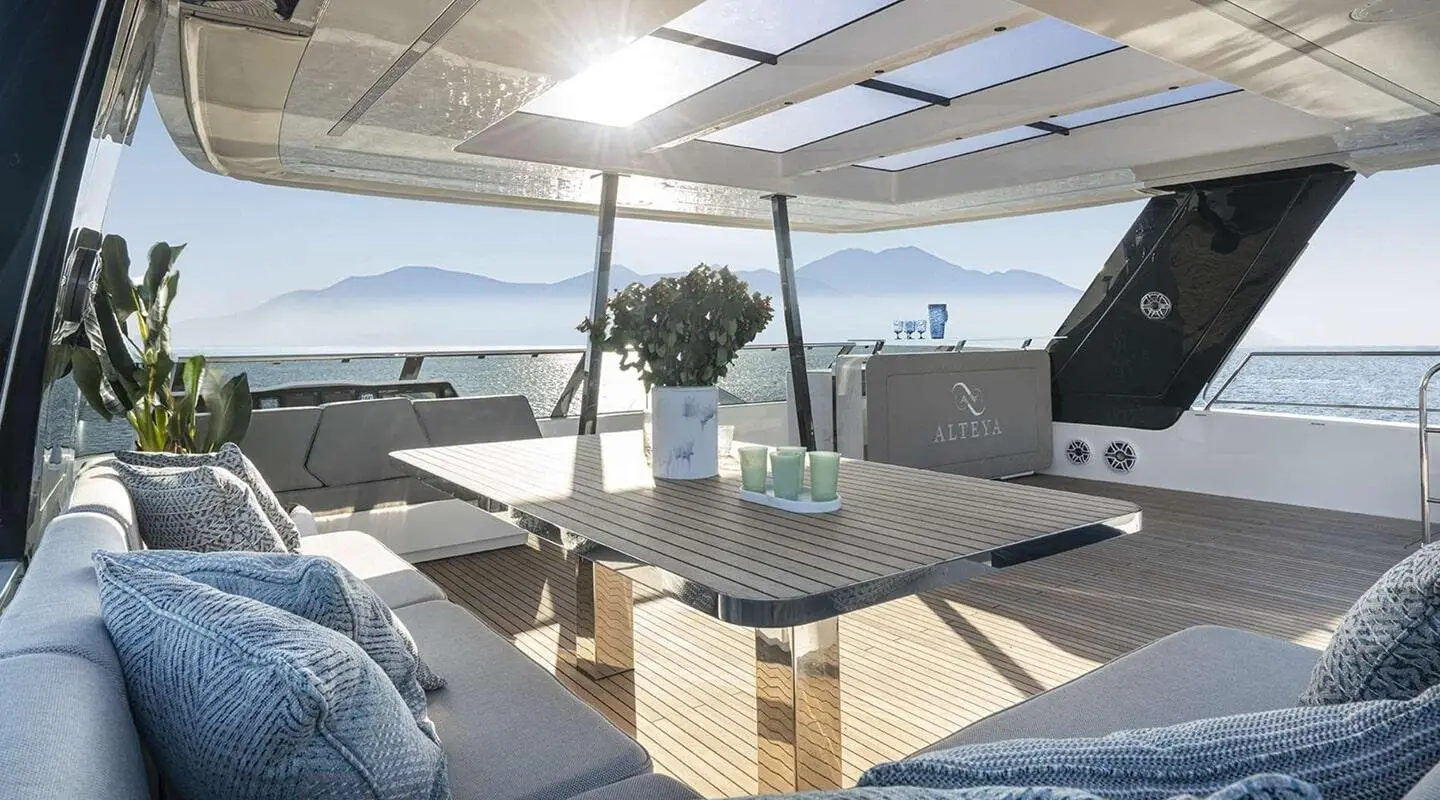 Yacht Alteya aft deck with seating area, table, and sea view