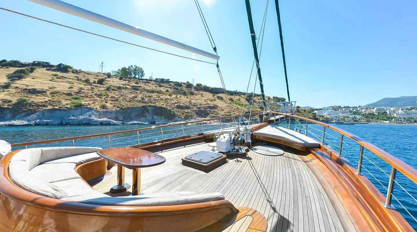 On the Lady Christa yacht deck with ropes, sails, and blue water ahead