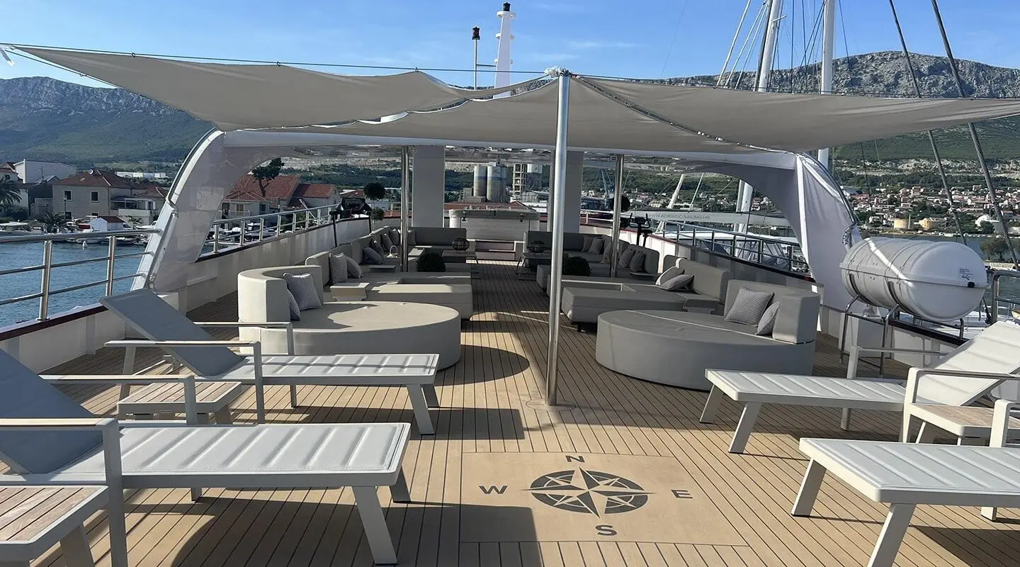 Melody motor yacht sun deck with lounge chairs under a canopy