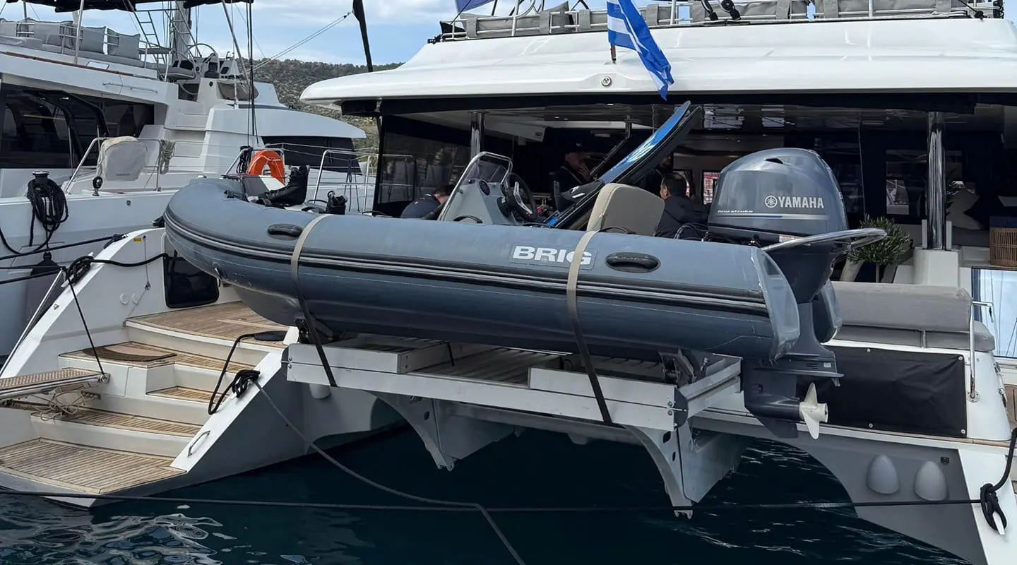 Atlantis yacht with a dinghy hanging on a davit on the aft deck