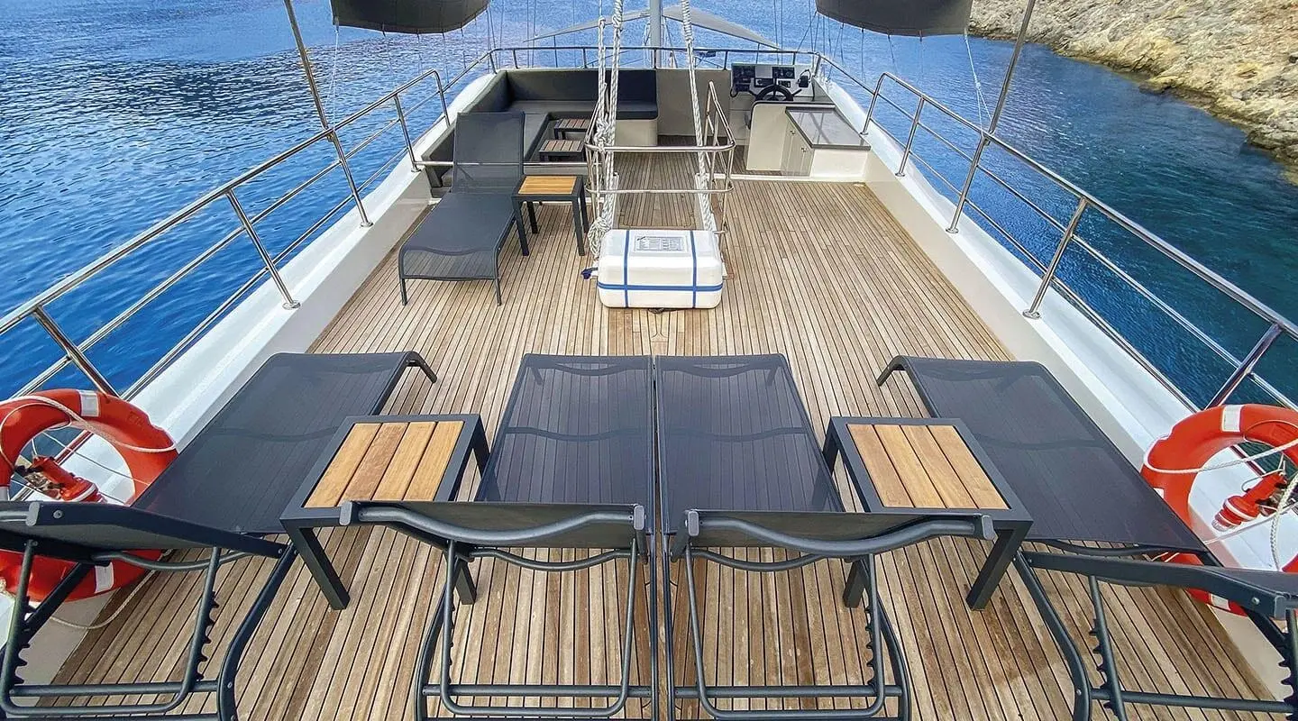 Upper deck of Maske 5 gulet showing seating, wooden floor, and stairs