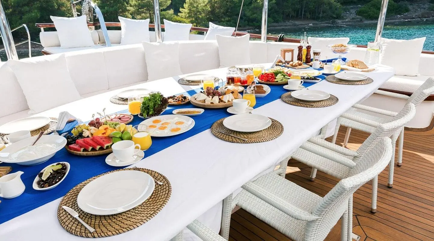Gulet Halcon Del Mar table set for dining on deck with plates and drinks