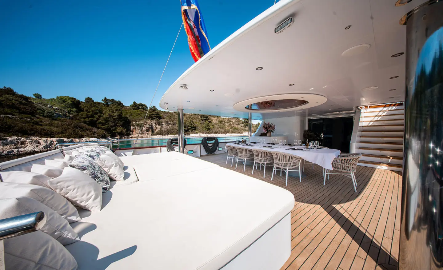 Nocturno yacht deck at sunset with white glossy surface and seating