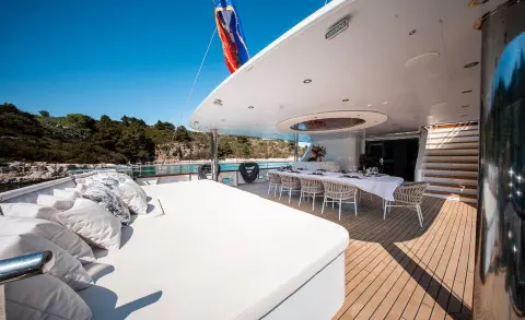 Nocturno yacht deck at sunset with white glossy surface and seating