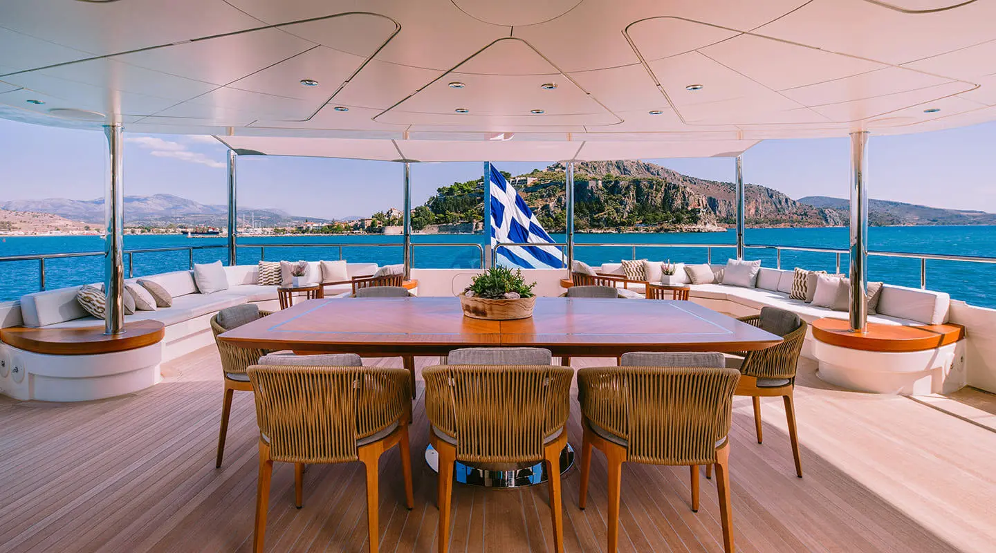 Xana motor yacht upper deck aft seating with ocean view and blue skies