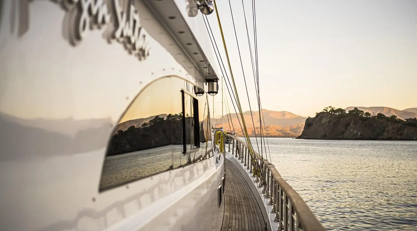 Side deck view of Belgin Sultan gulet with railings and calm water