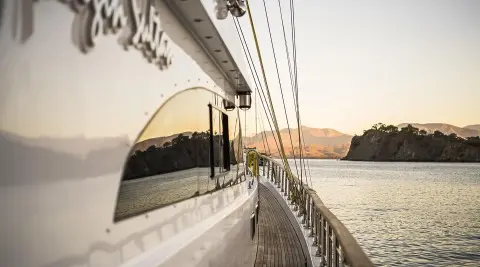 Side deck view of Belgin Sultan gulet with railings and calm water