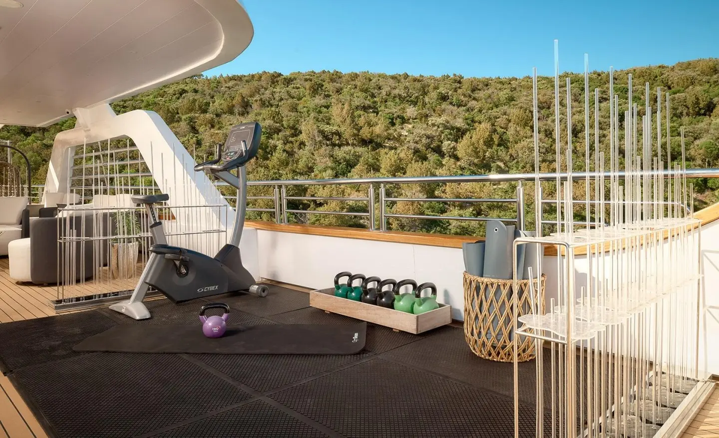 Cristal yacht deck view with ropes, wooden railing, and blue sea horizon