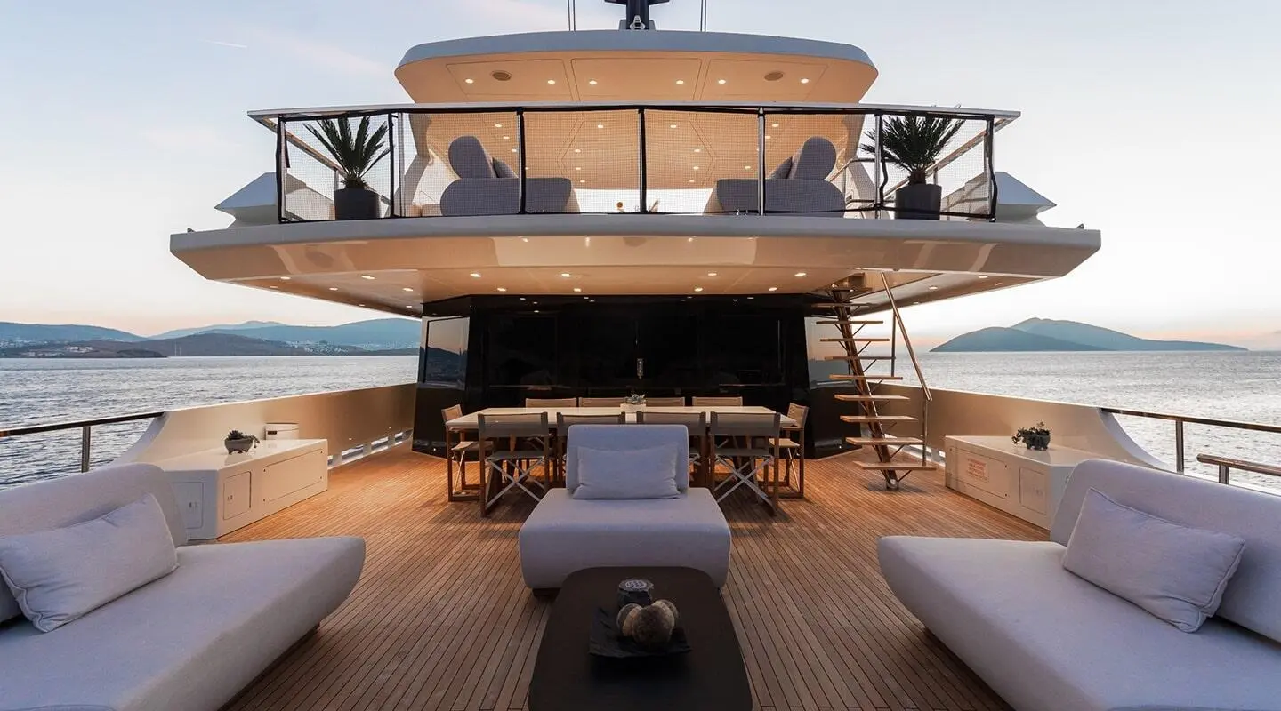 Front view of Illusion II yacht on a sunny day, teak deck and open stern
