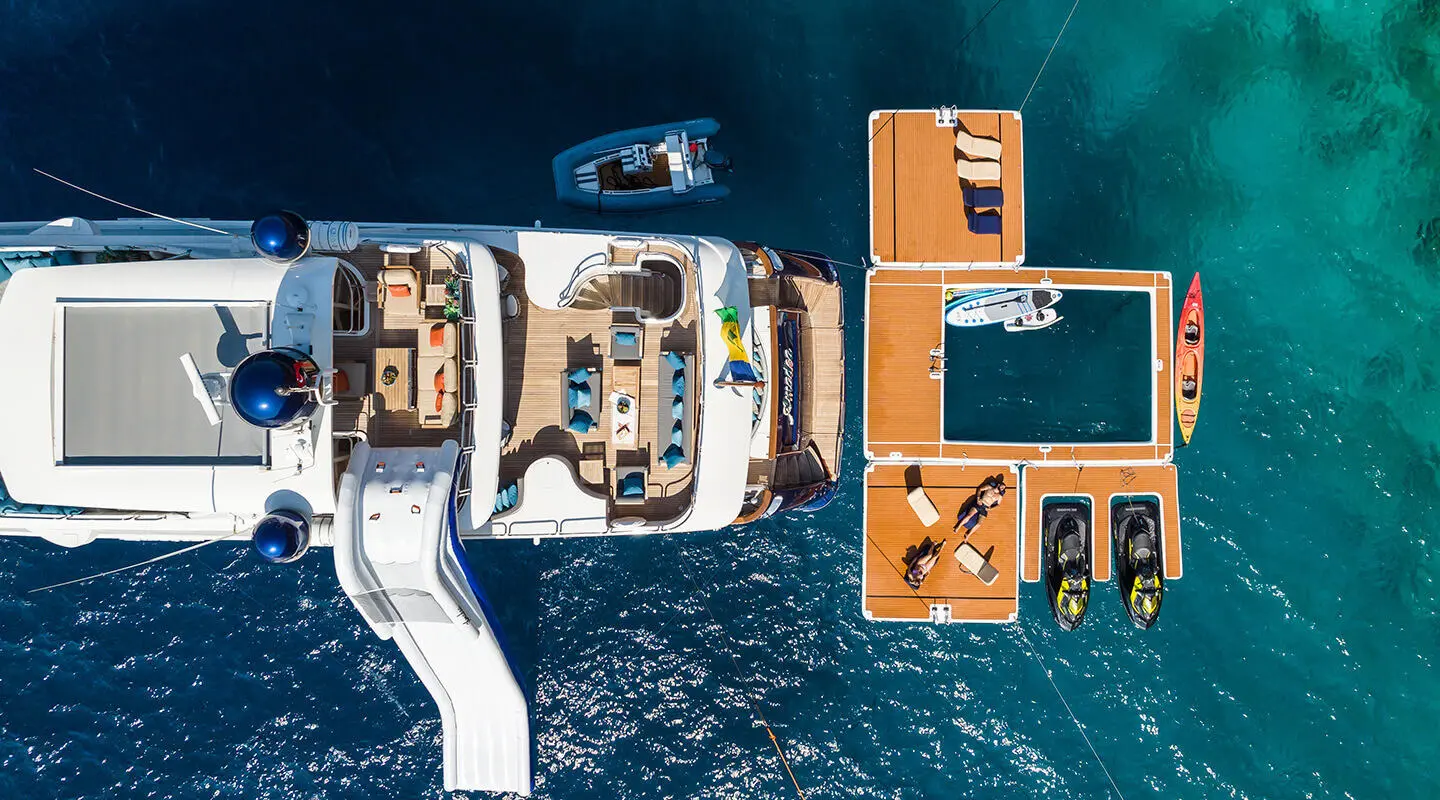 Aerial view of Amadea yacht with upper deck seating and swimming platform