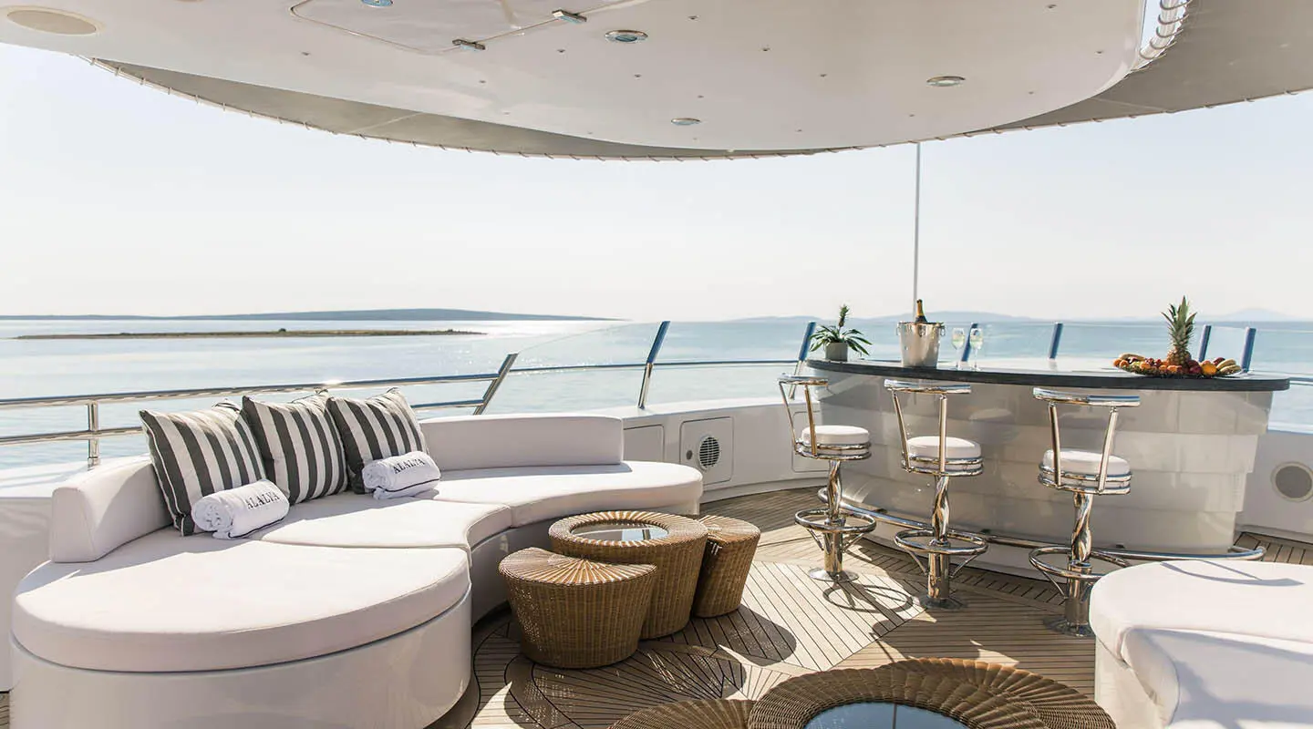 Alalya yacht deck lounge at sunset with seating and ocean view