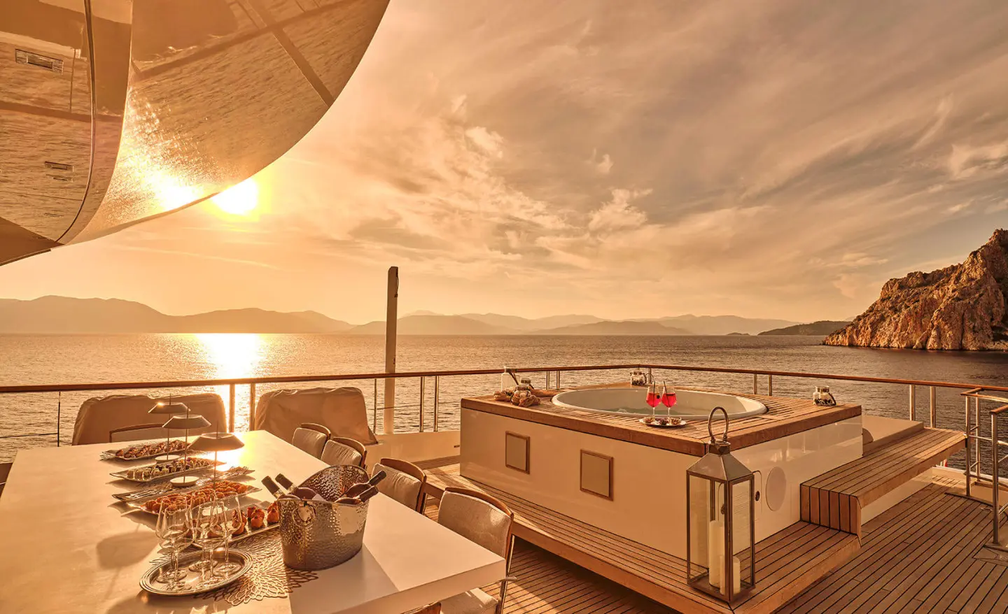 La Pellegrina 1 yacht at sunset with dining setup on deck and calm sea