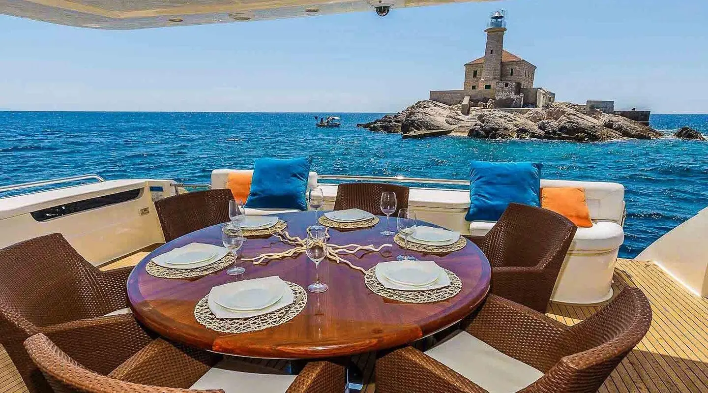 Miss Katariina yacht dining on deck with sunset and sea view