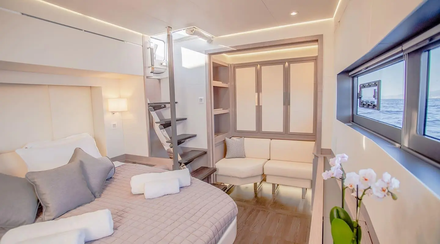 D2 motor yacht interior with double cabin, beige bedding and built-in wardrobe
