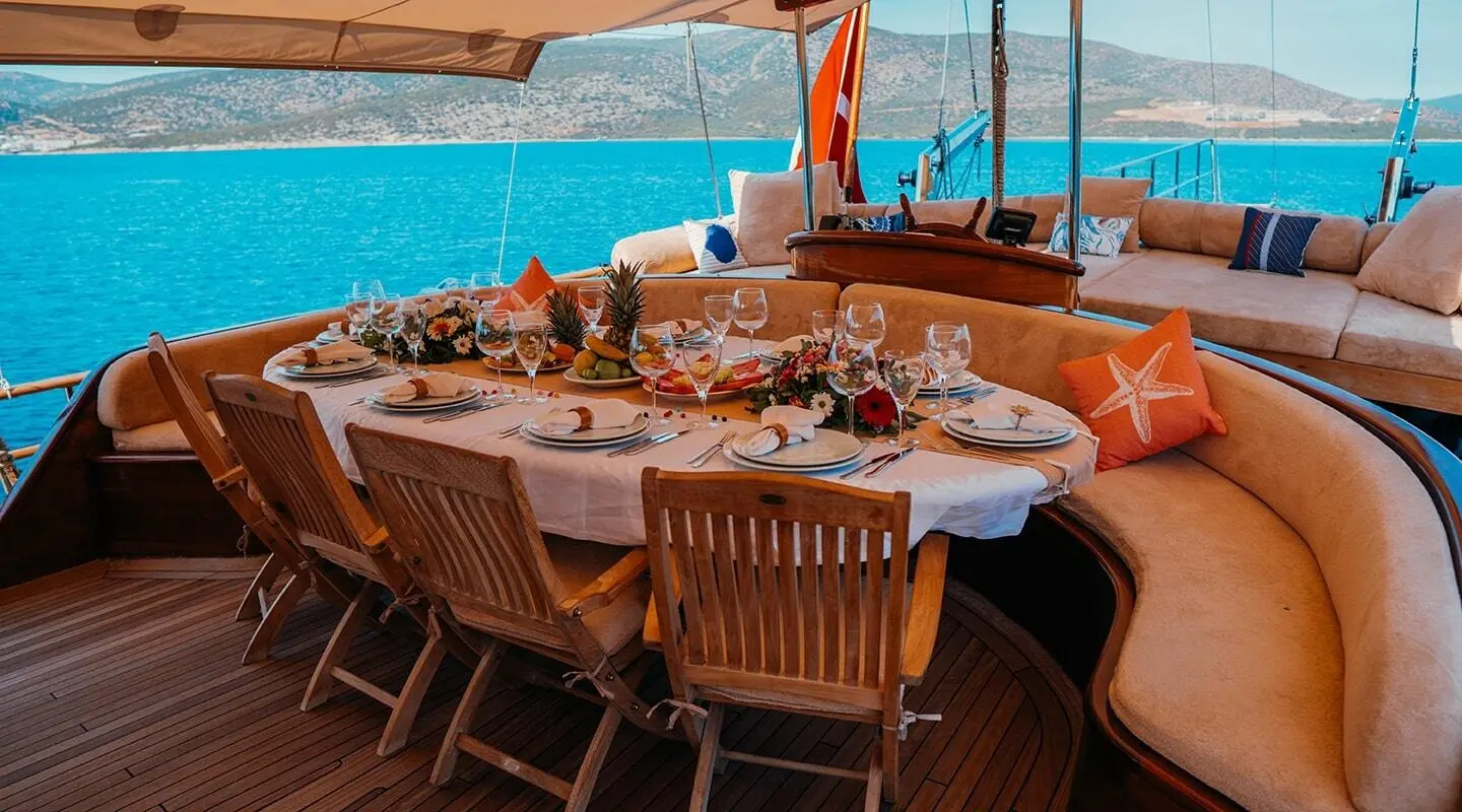 aft deck dining area on Wicked Felina gulet with wooden table and chairs