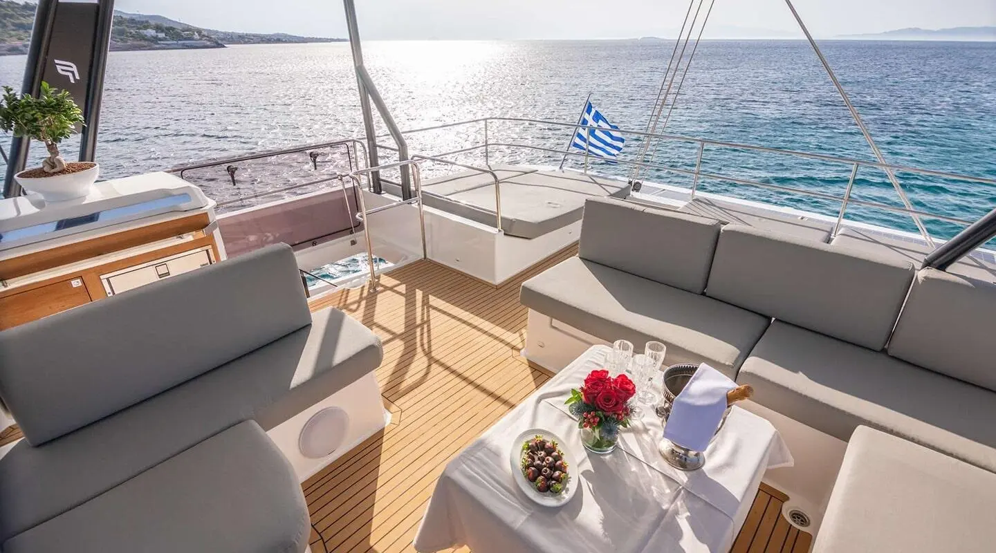 Yacht Astoria flybridge seating area with table and flowers, ocean view