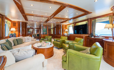 Amadea yacht onboard saloon with luxurious wood and colorful chairs