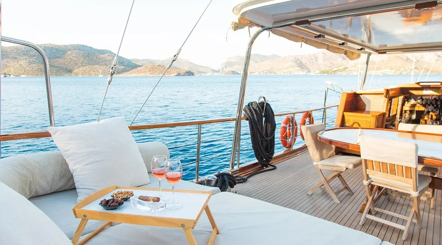 Derin Deniz yacht deck at sunset with sunloungers and seating overlooking blue sea