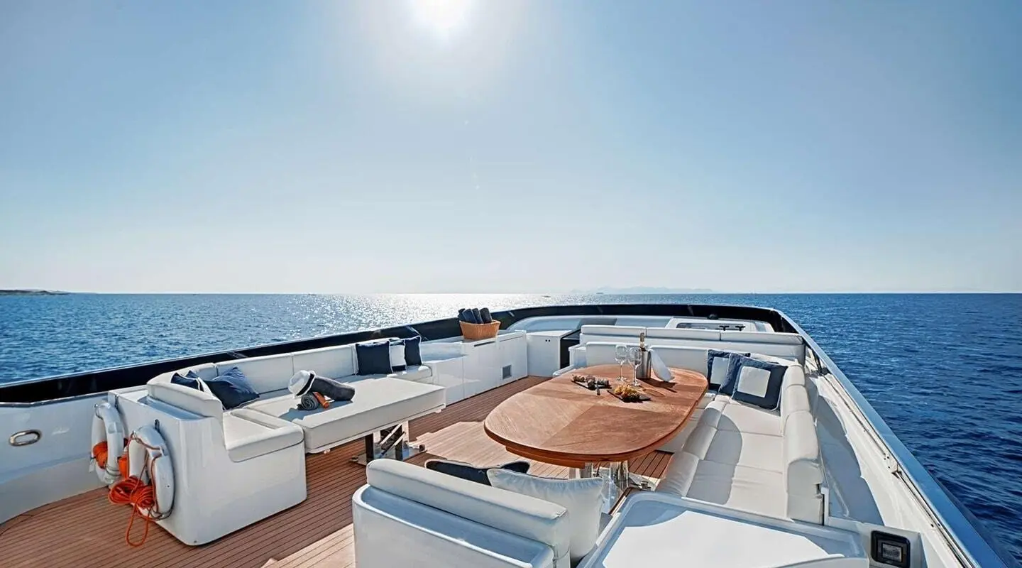 Deck of luxury yacht Zoi with sun loungers and seating on white surface