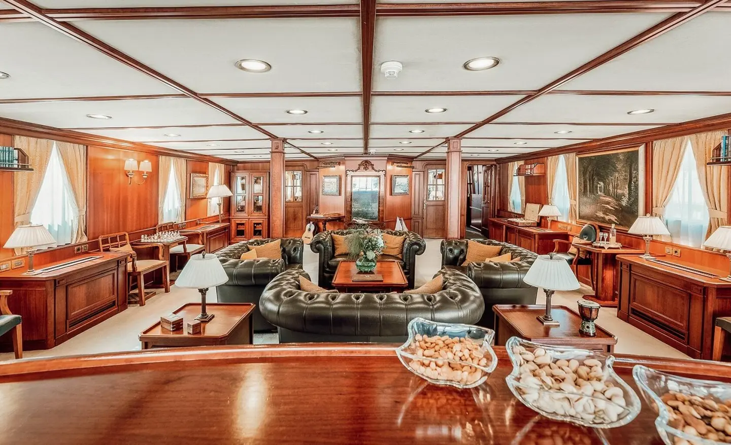 Seagull II yacht saloon interior with polished wood, seating, and dining table